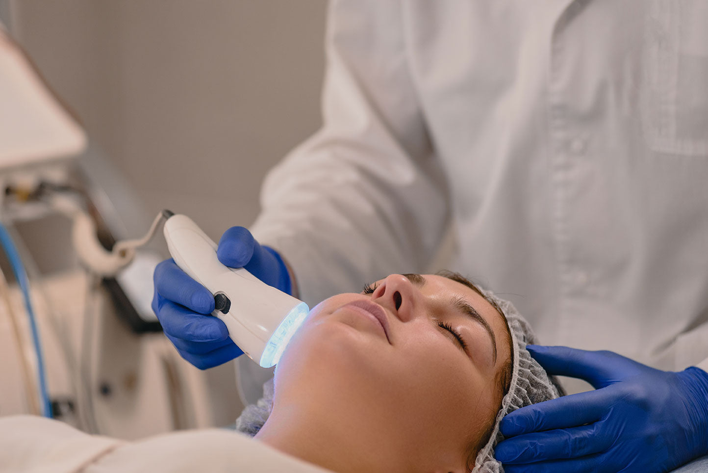 Woman having color light therapy to stimulate facial skin wellbeing