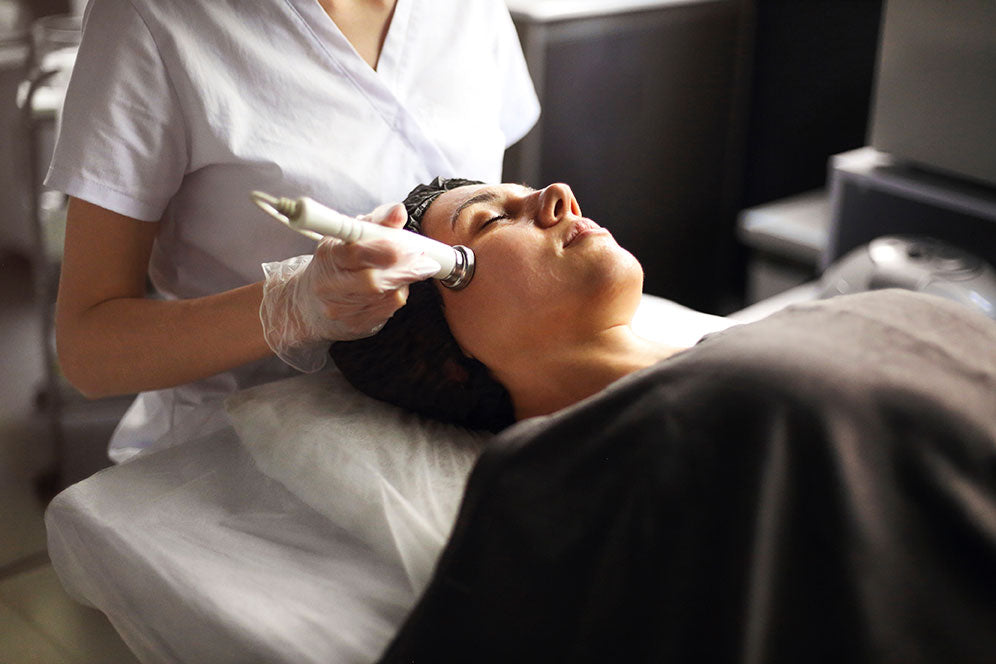 Beautician using machine for radiofrequency lifting